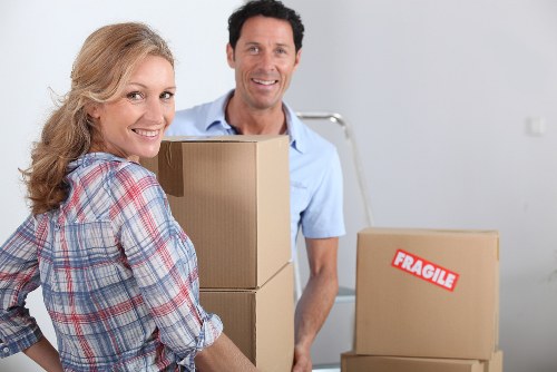 Two movers carrying furniture during a Redbridge move